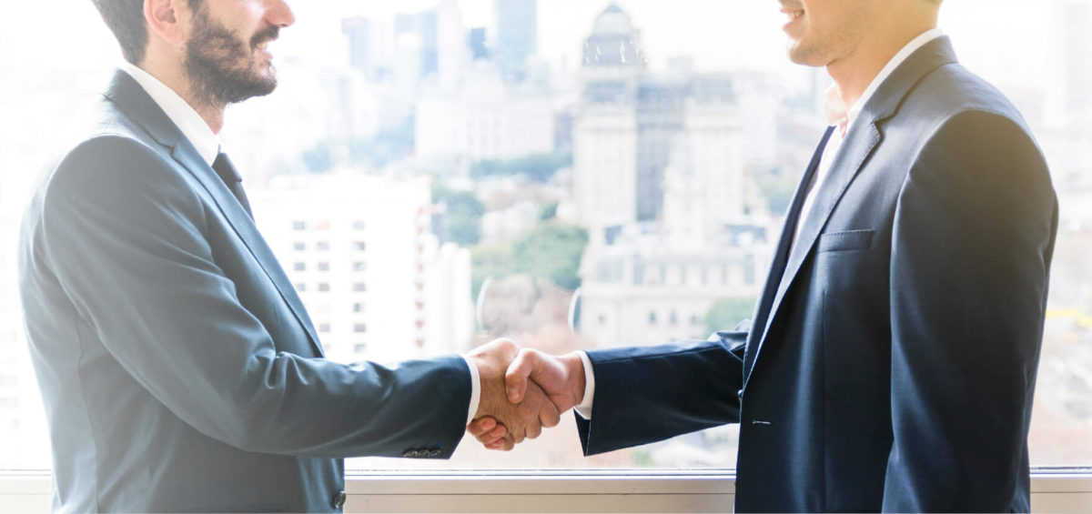 An insurance agent shaking hands with a new business partner.