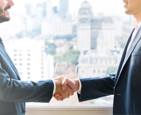 An insurance agent shaking hands with a new business partner.
