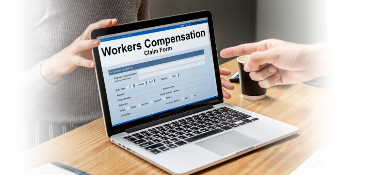 A person asking questions at a laptop with a workers' compensation claim form.